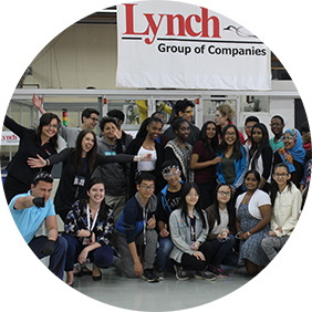 Several young people huddled together with Lynch Logo overhead